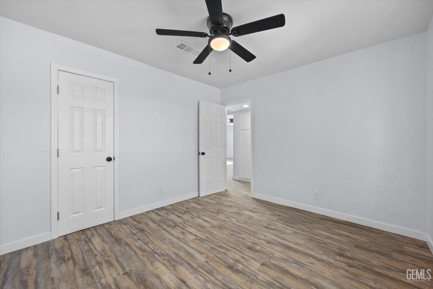 Undisclosed Address Bakersfield, CA 93306 - Photo 15 of 29 a view of room with hardwood floor and ceiling fan