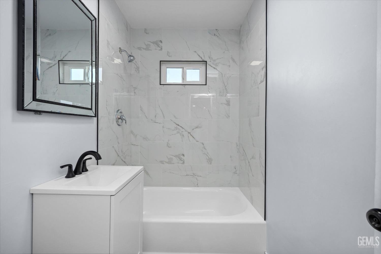 Undisclosed Address Bakersfield, CA 93306 - Photo 17 of 29 a bathroom with a sink and mirror with bathtub