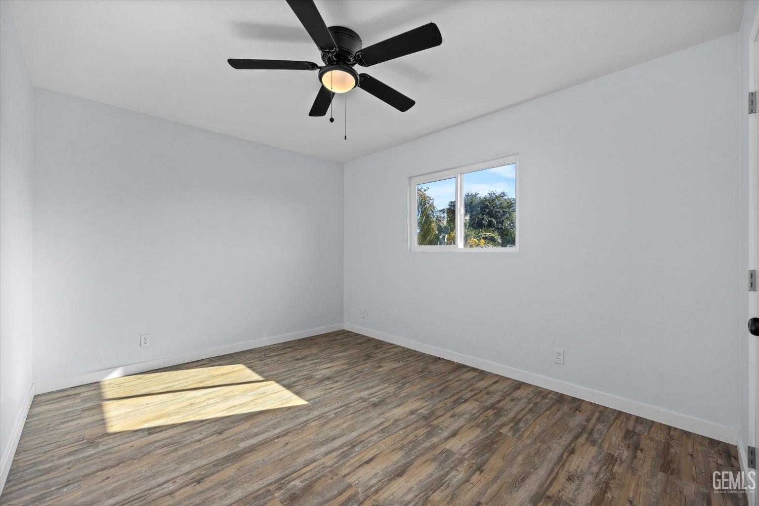 Undisclosed Address Bakersfield, CA 93306 - Photo 18 of 29 an empty room with wooden floor and windows