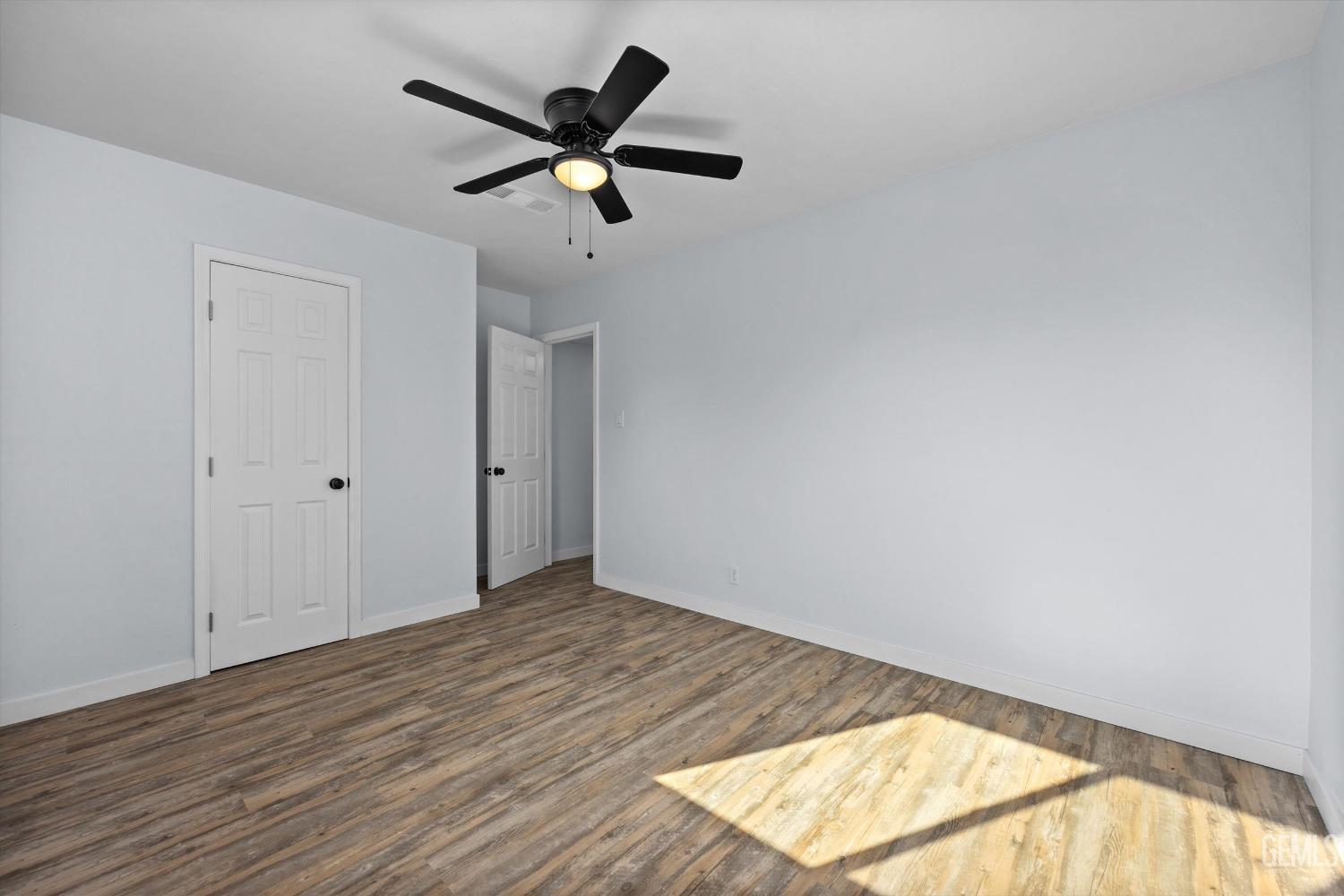Undisclosed Address Bakersfield, CA 93306 - Photo 19 of 29 an empty room with wooden floor and windows
