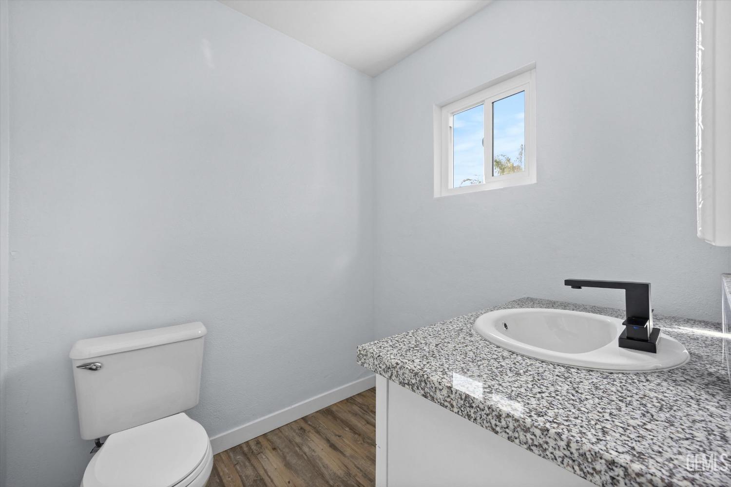 Undisclosed Address Bakersfield, CA 93306 - Photo 20 of 29 a bathroom with a granite countertop sink and toilet