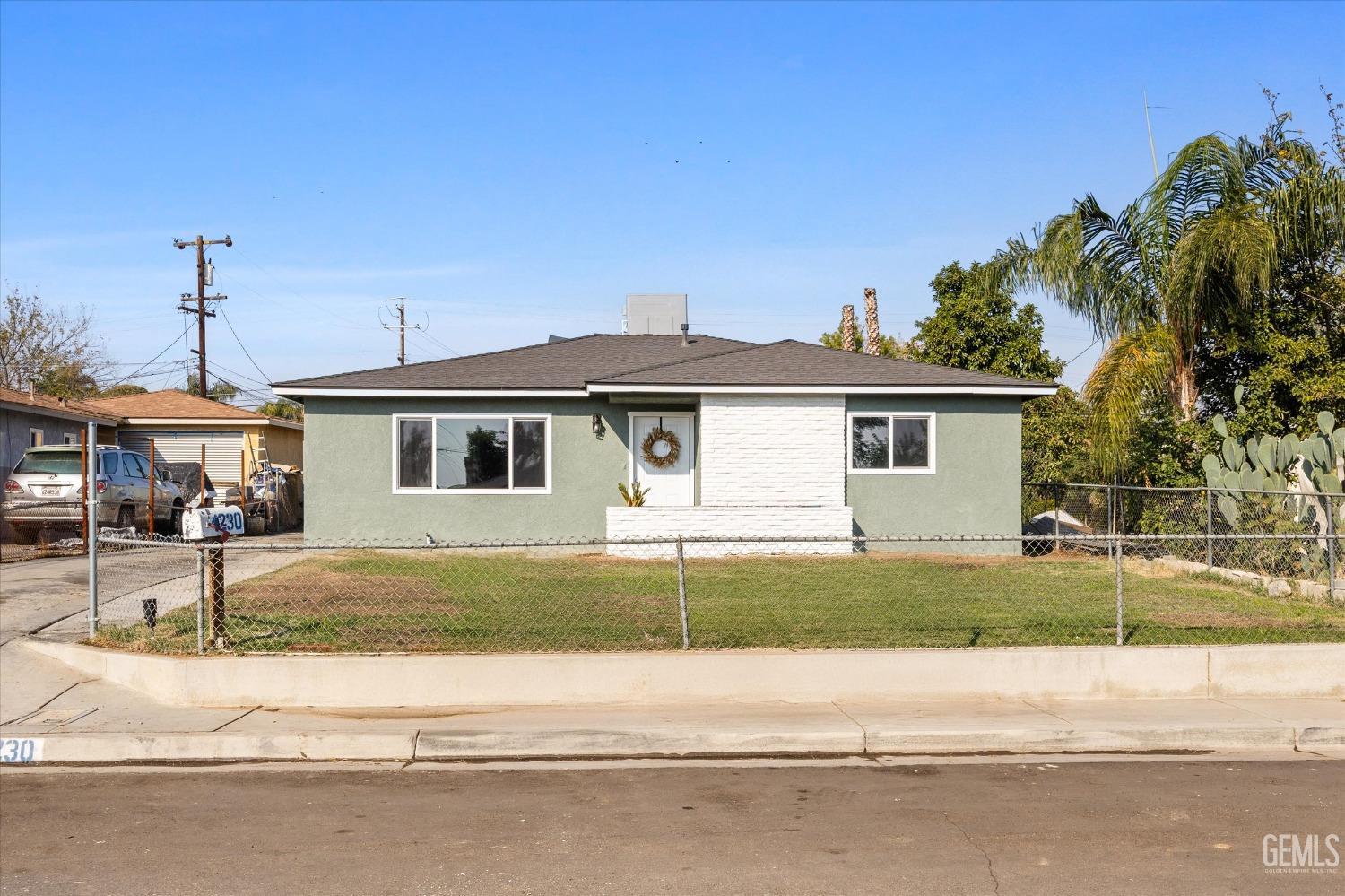 Undisclosed Address Bakersfield, CA 93306 - Photo 2 of 29 a front view of a house with a yard