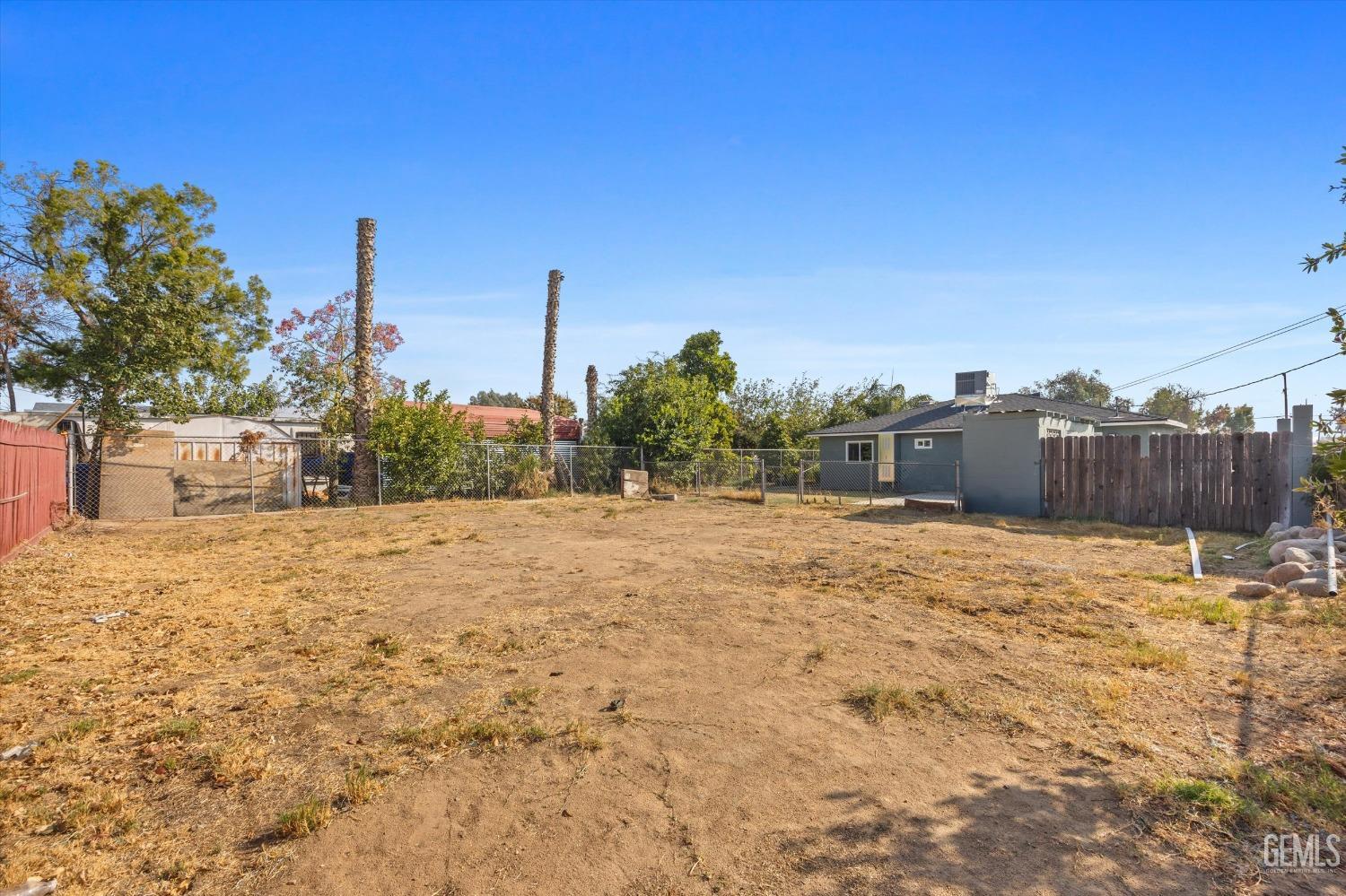 Undisclosed Address Bakersfield, CA 93306 - Photo 29 of 29 a backyard of a house with a yard