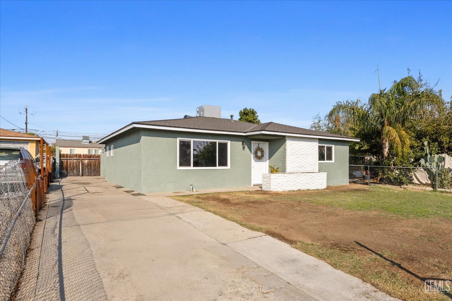 Undisclosed Address Bakersfield, CA 93306 - Photo 3 of 29 a yellow house with trees in front of it