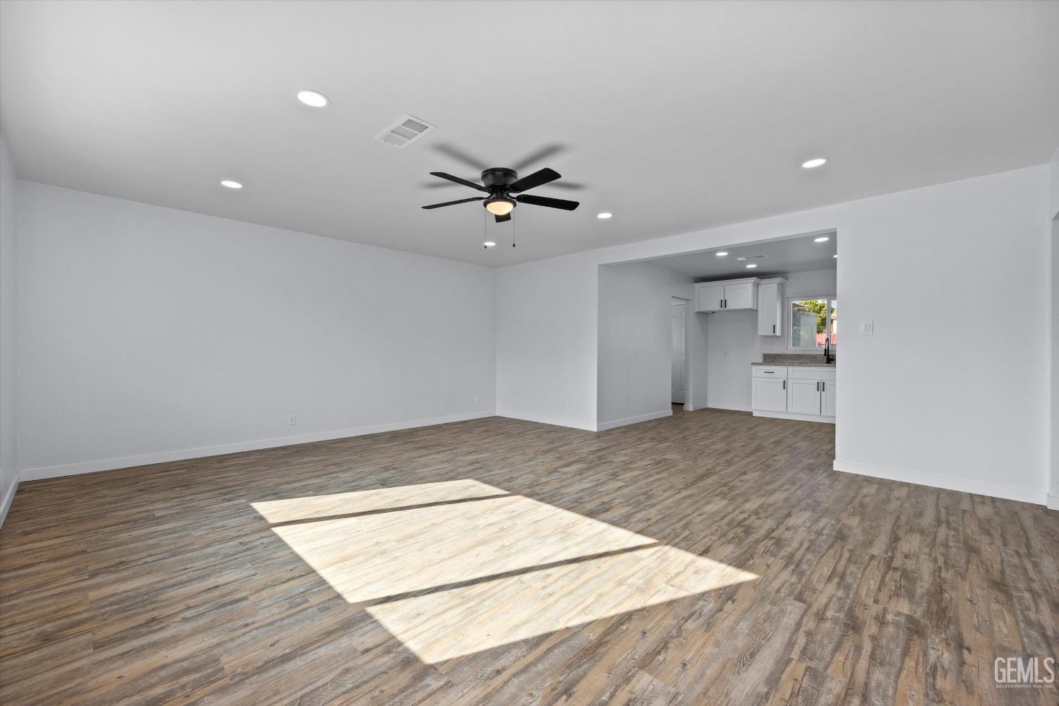 Undisclosed Address Bakersfield, CA 93306 - Photo 5 of 29 an empty space with wooden floor and a ceiling fan