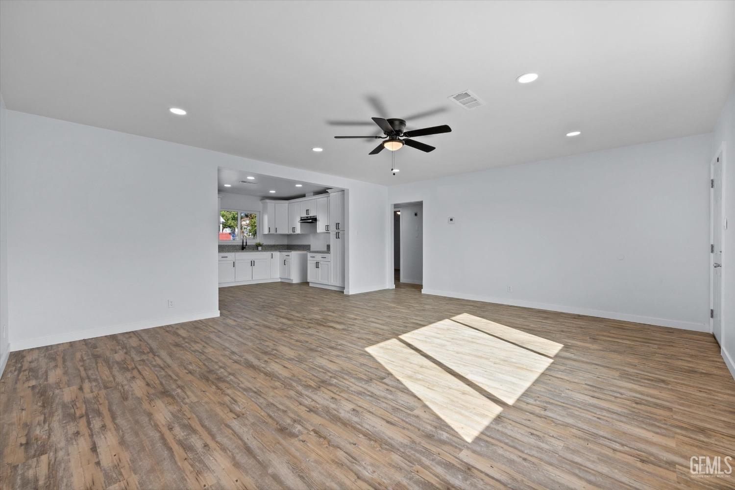Undisclosed Address Bakersfield, CA 93306 - Photo 8 of 29 a view of empty room with wooden floor and a ceiling fan