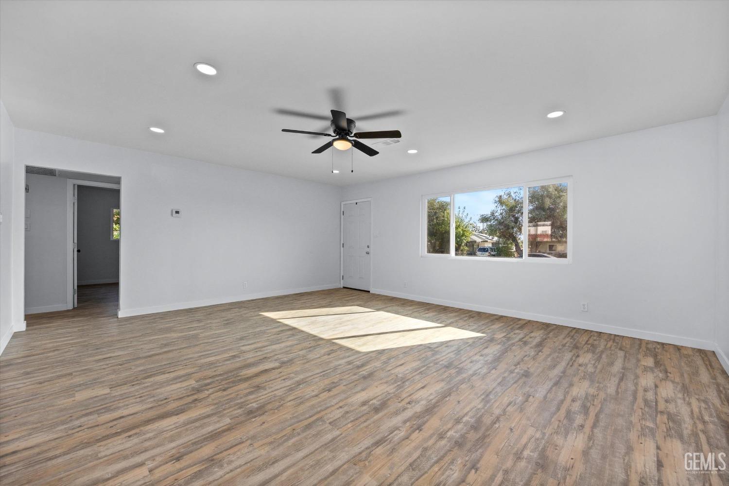 Undisclosed Address Bakersfield, CA 93306 - Photo 9 of 29 wooden floor in an empty room with a window