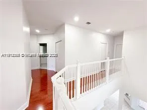 a bathroom with a tub a mirror and a shower