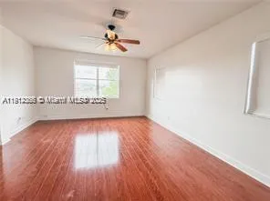 a view of a chandelier fan and entryway