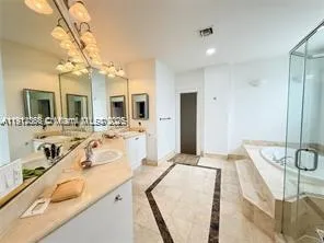 a spacious bathroom with a granite countertop sink mirror and bathtub