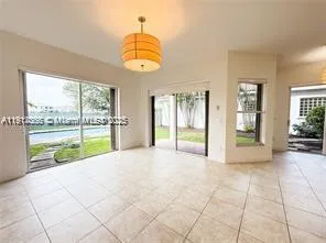 a kitchen with granite countertop a refrigerator and a stove top oven