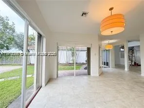 a kitchen with granite countertop a sink a stove and cabinets