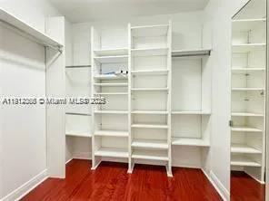 a view of walk in closet with empty racks