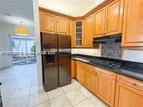 a view of swimming pool with lawn chairs and plants