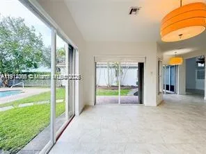 an empty room with a window and a ceiling fan