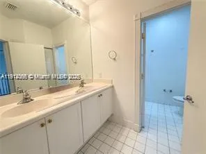 a bathroom with a double vanity sink mirror and