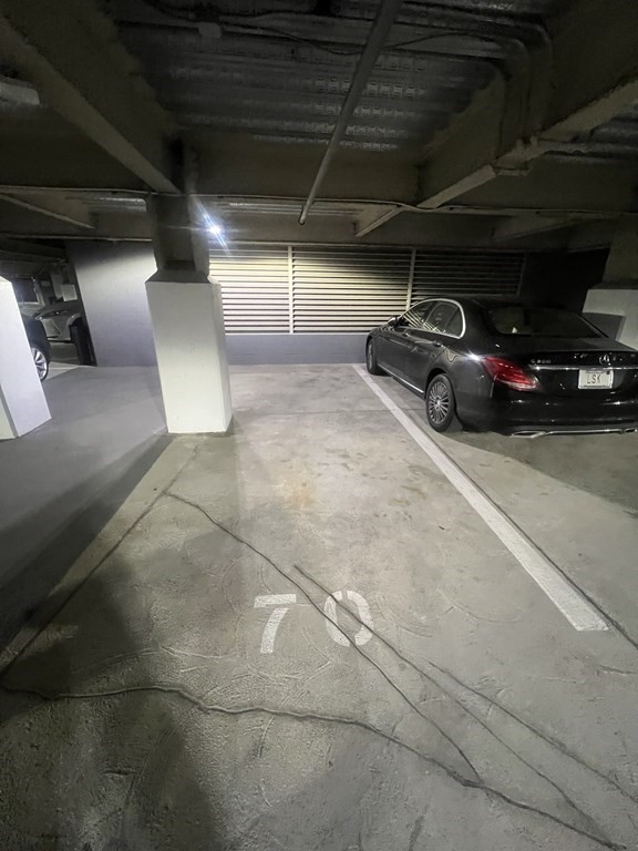 a view of parking garage with cars parked