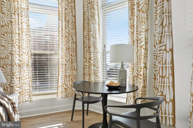 a living room with furniture kitchen view and a chandelier