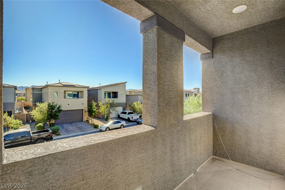 9688 Rankin Rdg Court Las Vegas, NV 89178 - Photo 42 of 53 A well-lit balcony offers tranquil neighborhood views under clear blue skies.