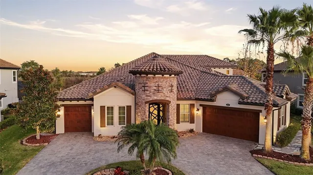 a front view of residential houses with yard and mountain view in front of it