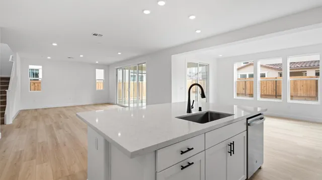 a view of large kitchen with a sink and cabinets