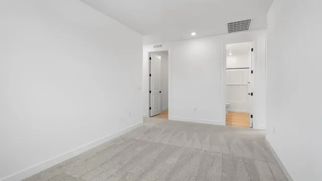 an empty room with closet and wooden floor