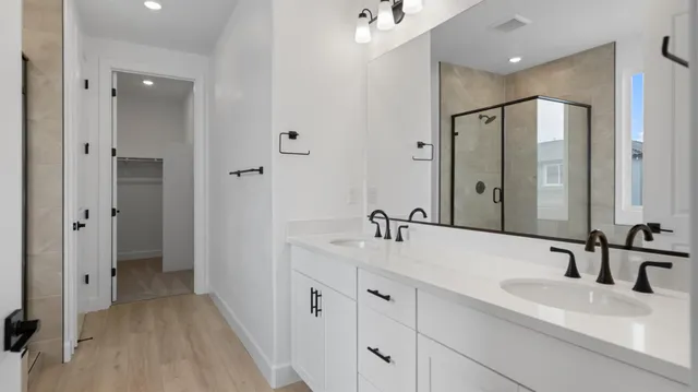 a bathroom with a double vanity sink and mirror