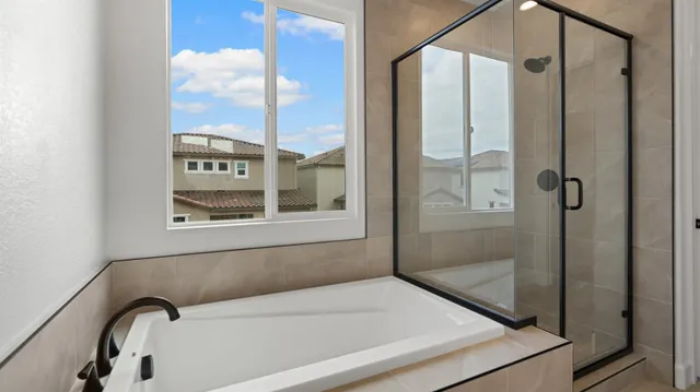 a bathroom with a bathtub and a shower