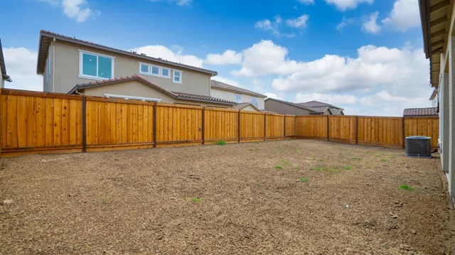 a view of a house with wooden fence