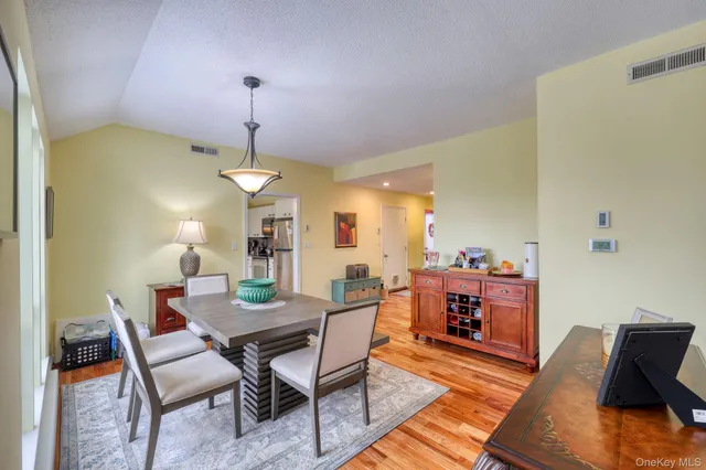 a dining room with furniture and wooden floor