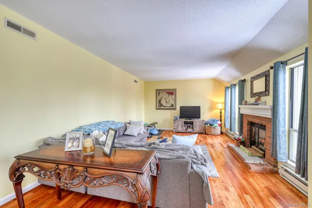 a living room with furniture a fireplace and a flat screen tv