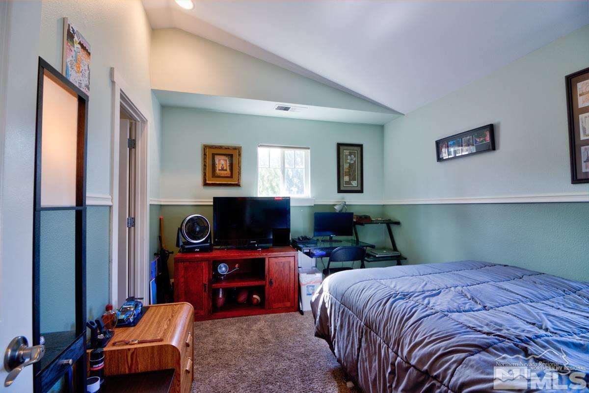 5001 Fall Colors Court Reno, NV 89519 - Photo 13 of 36 a bedroom with a bed and a flat screen tv