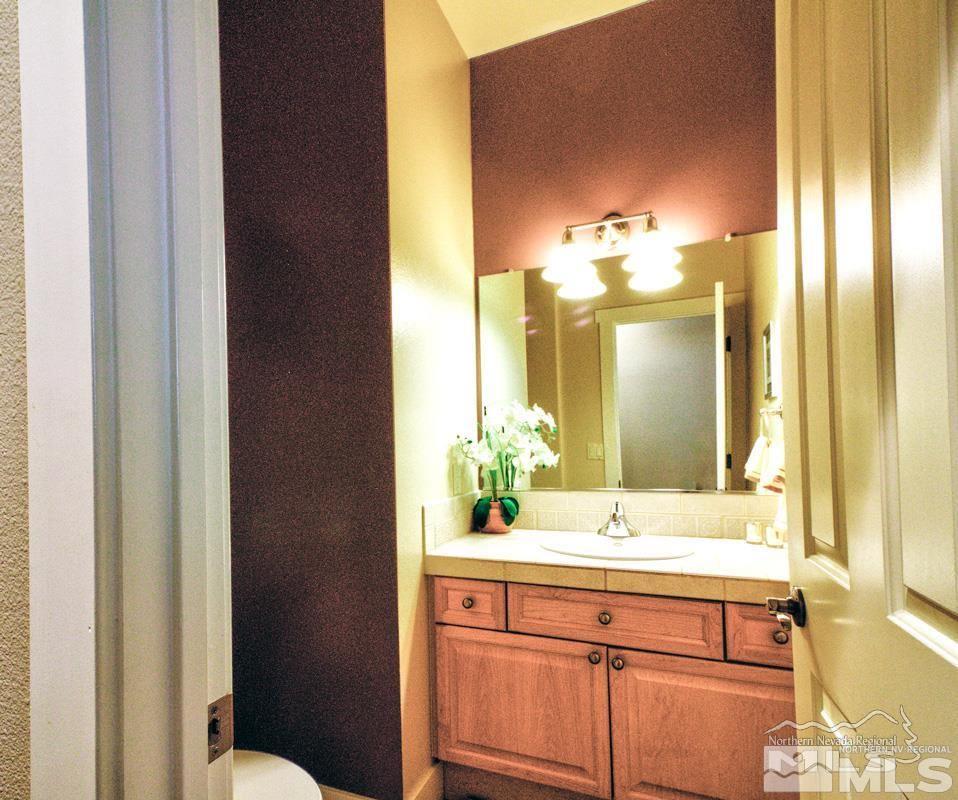 5001 Fall Colors Court Reno, NV 89519 - Photo 14 of 36 a bathroom with a double vanity sink and a mirror