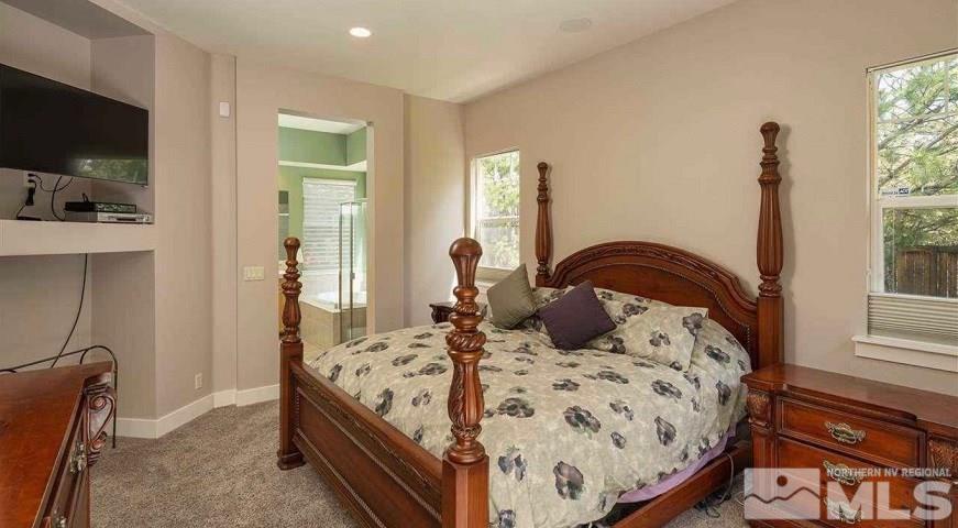 5001 Fall Colors Court Reno, NV 89519 - Photo 22 of 36 a bedroom with a bed and flat screen tv