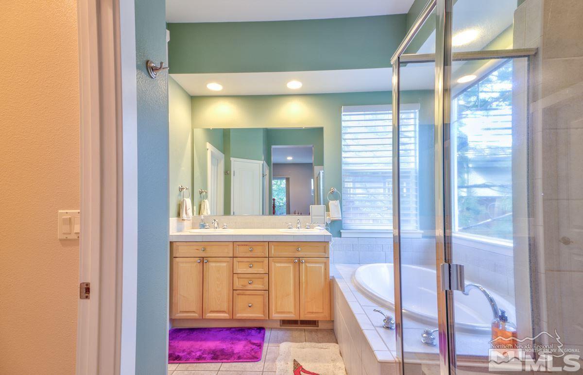 5001 Fall Colors Court Reno, NV 89519 - Photo 25 of 36 a bathroom with a tub and shower