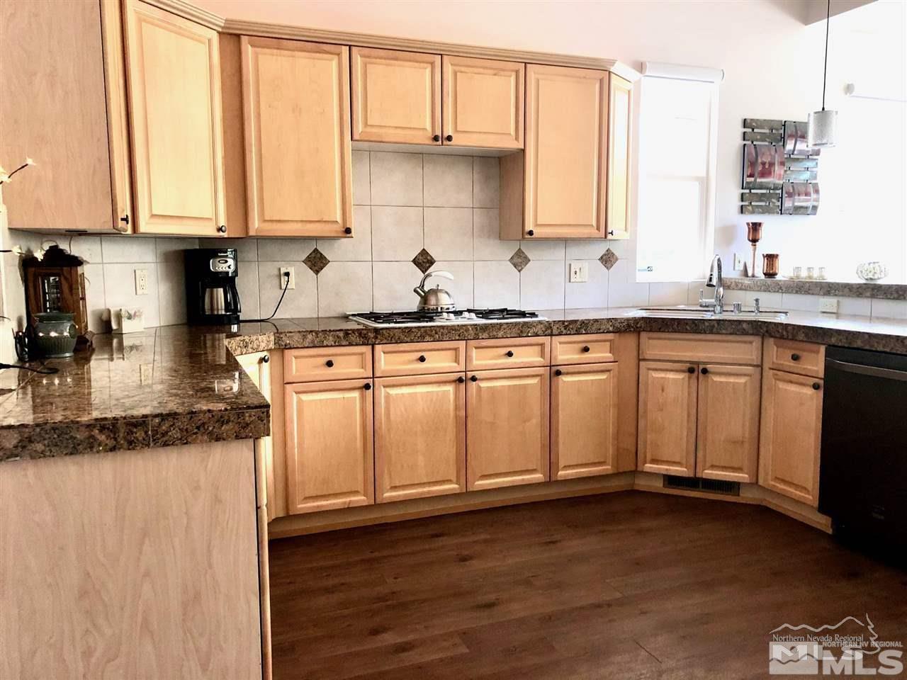 5001 Fall Colors Court Reno, NV 89519 - Photo 7 of 36 a kitchen with granite countertop wooden cabinets and a sink