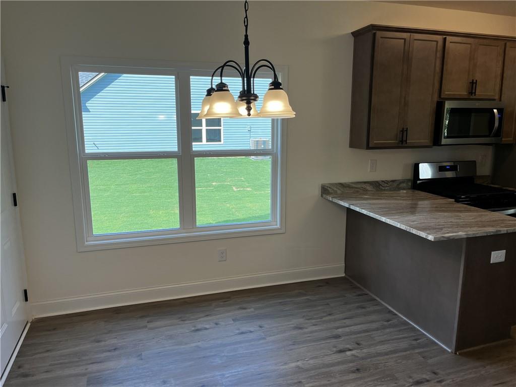 1932 Cochran Ridge Road Hiram, GA 30141 - Photo 6 of 30 a kitchen with a sink wooden floor and a microwave