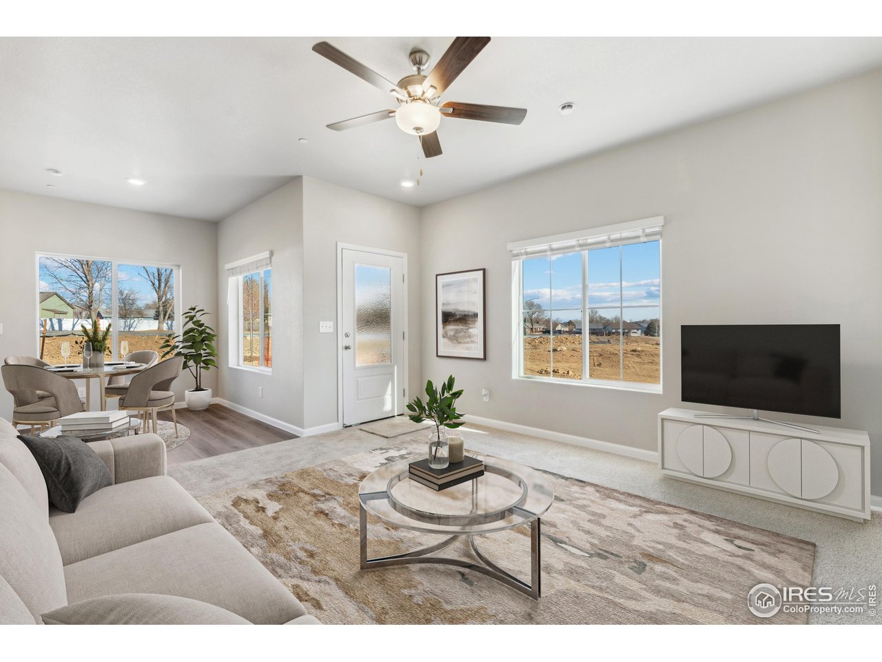 127 Robin Road Johnstown, CO 80534 - Photo 4 of 24 a living room with furniture a flat screen tv and a window