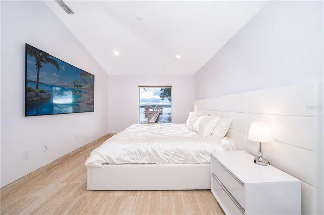 a bed sitting in a bedroom next to a window