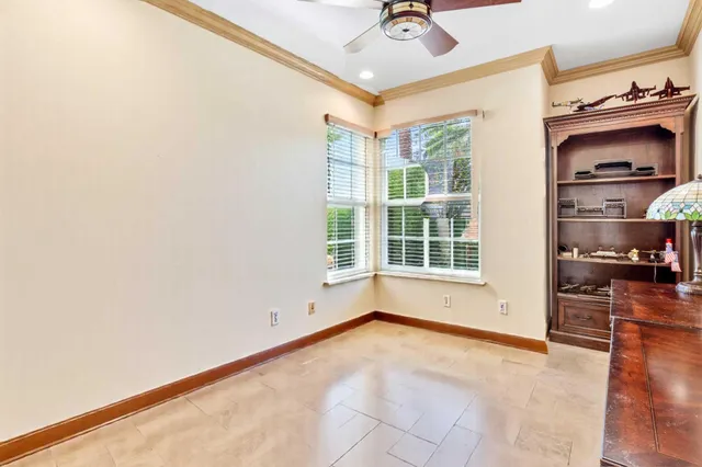 a spacious bedroom with a bed and a large window