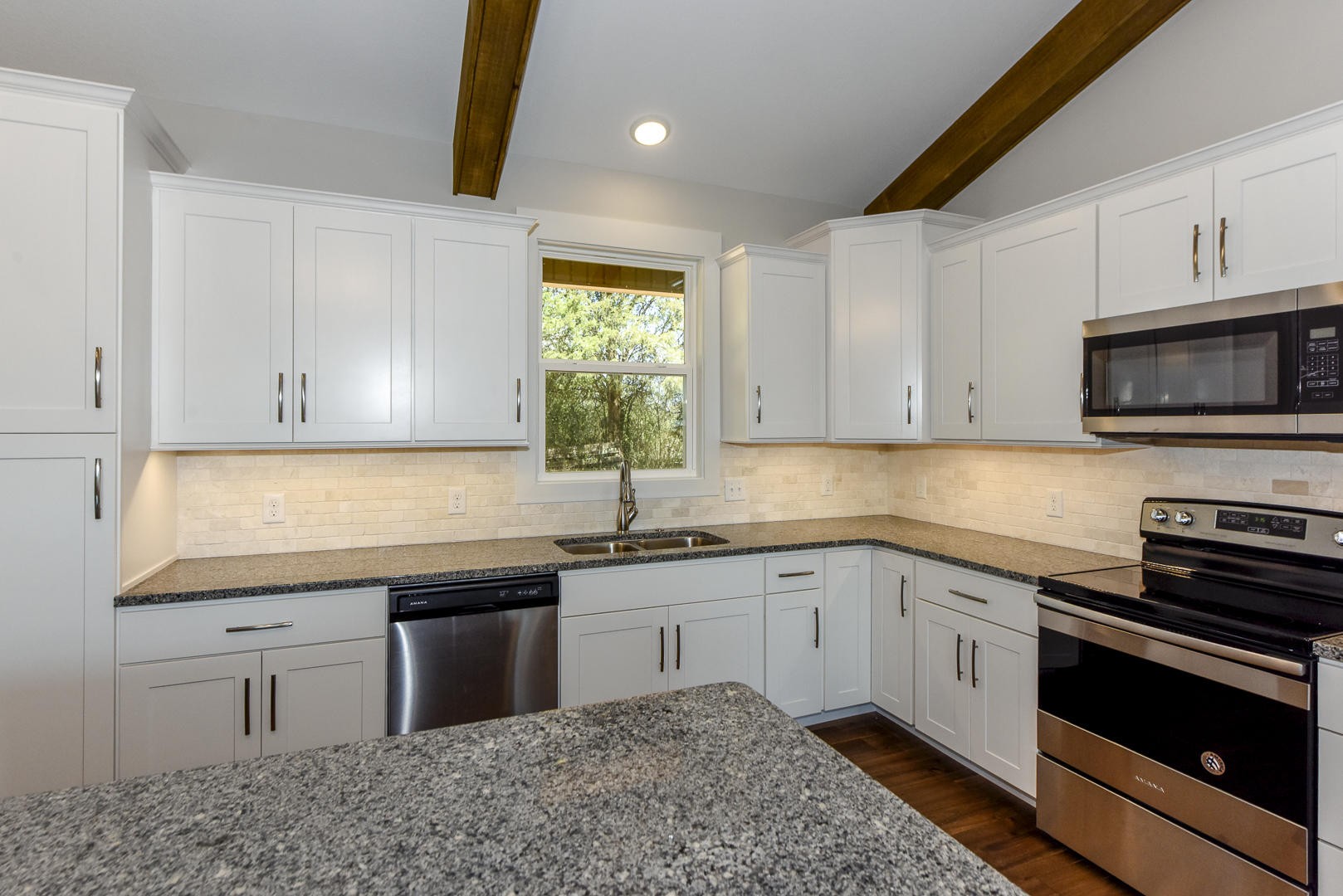 3059 New Blockhouse Road Maryville, TN 37803 - Photo 16 of 33 a kitchen with stainless steel appliances granite countertop a sink a stove a microwave and cabinets