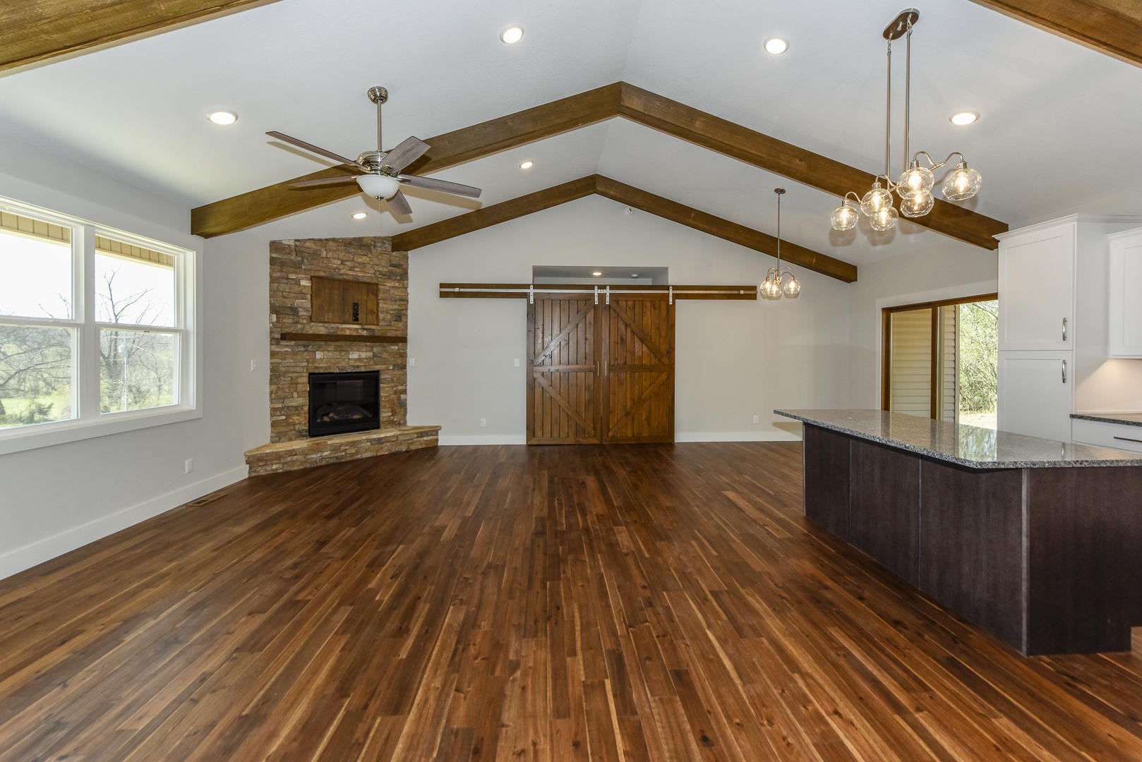 3059 New Blockhouse Road Maryville, TN 37803 - Photo 6 of 33 an empty room with wooden floor a ceiling fan and windows