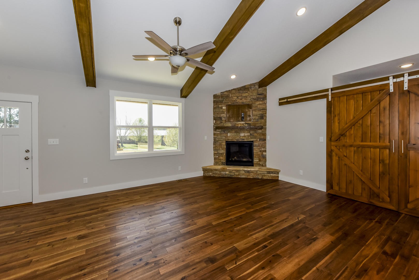 3059 New Blockhouse Road Maryville, TN 37803 - Photo 8 of 33 an empty room with wooden floor fan and windows