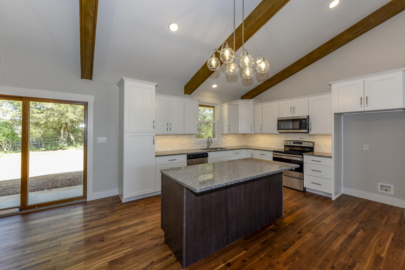 3059 New Blockhouse Road Maryville, TN 37803 - Photo 10 of 33 a kitchen with stainless steel appliances granite countertop wooden floors a stove a sink and a refrigerator