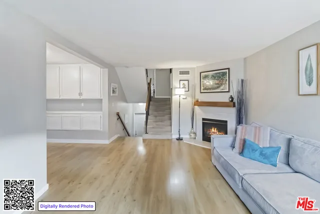 an empty room with wooden floor closet and windows
