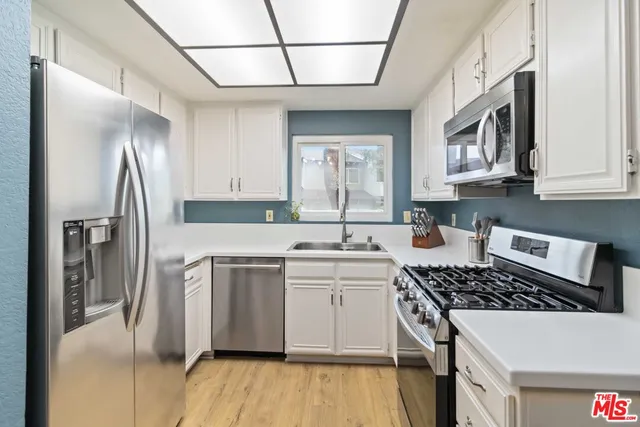 a living room with furniture cabinets and window