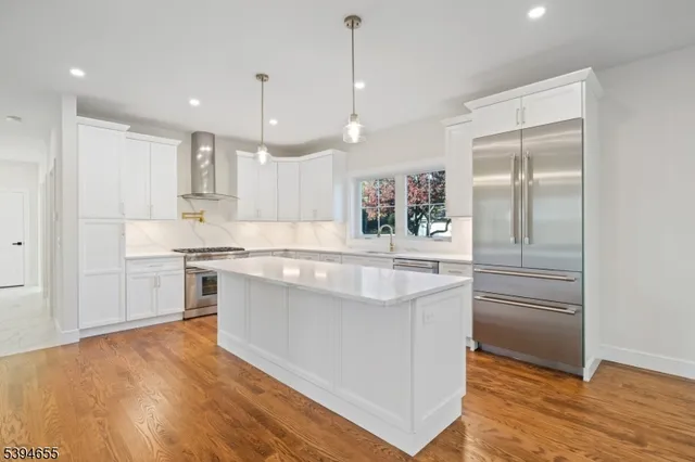 a bathroom with a granite countertop sink a toilet a mirror and shower