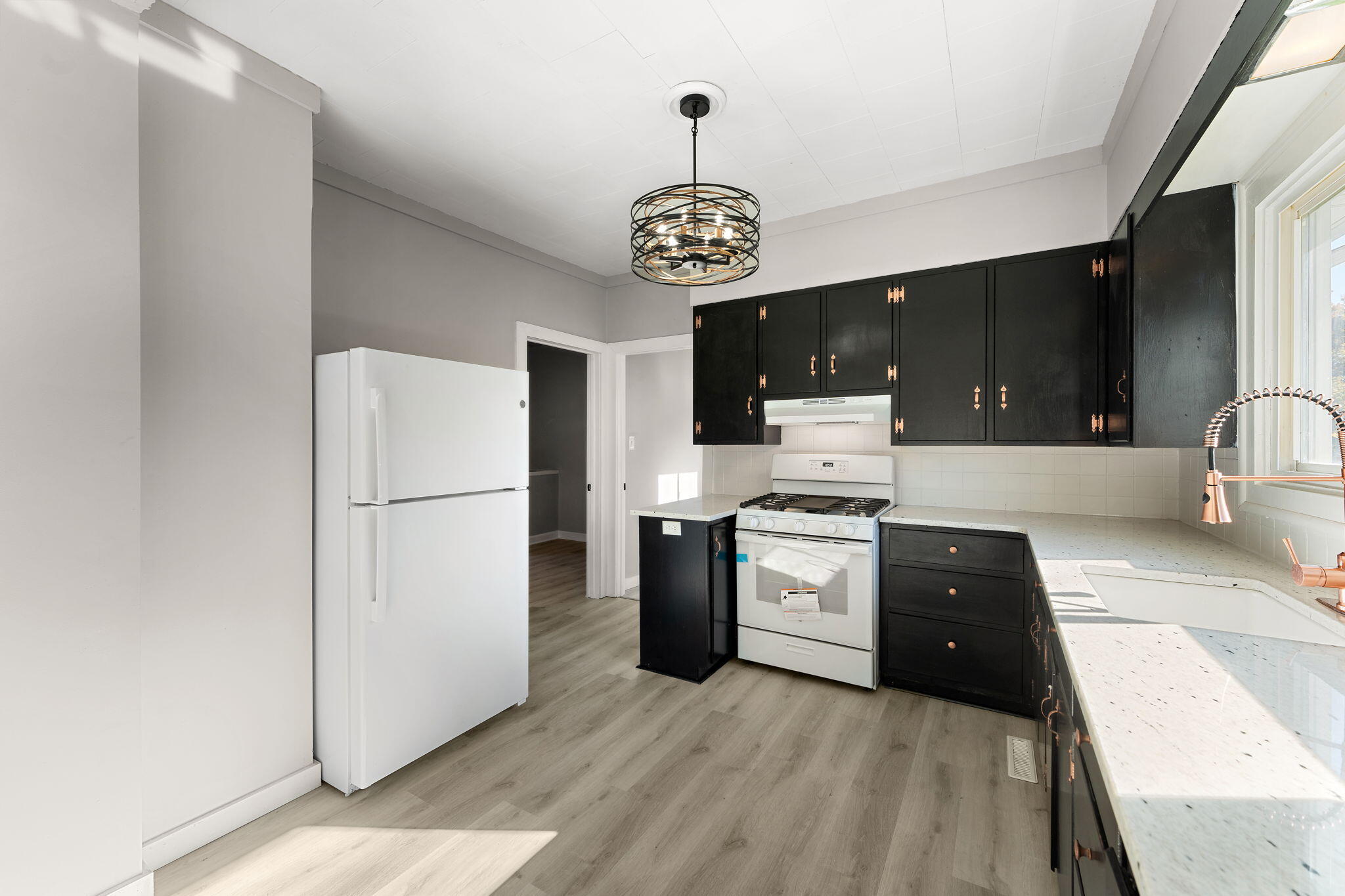 813 Carnation Street Southeast De Motte, IN 46310 - Photo 12 of 26 a kitchen with a refrigerator a stove top oven and a dishwasher with wooden floor