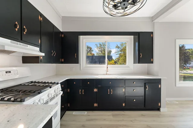 a kitchen with a stove and a window