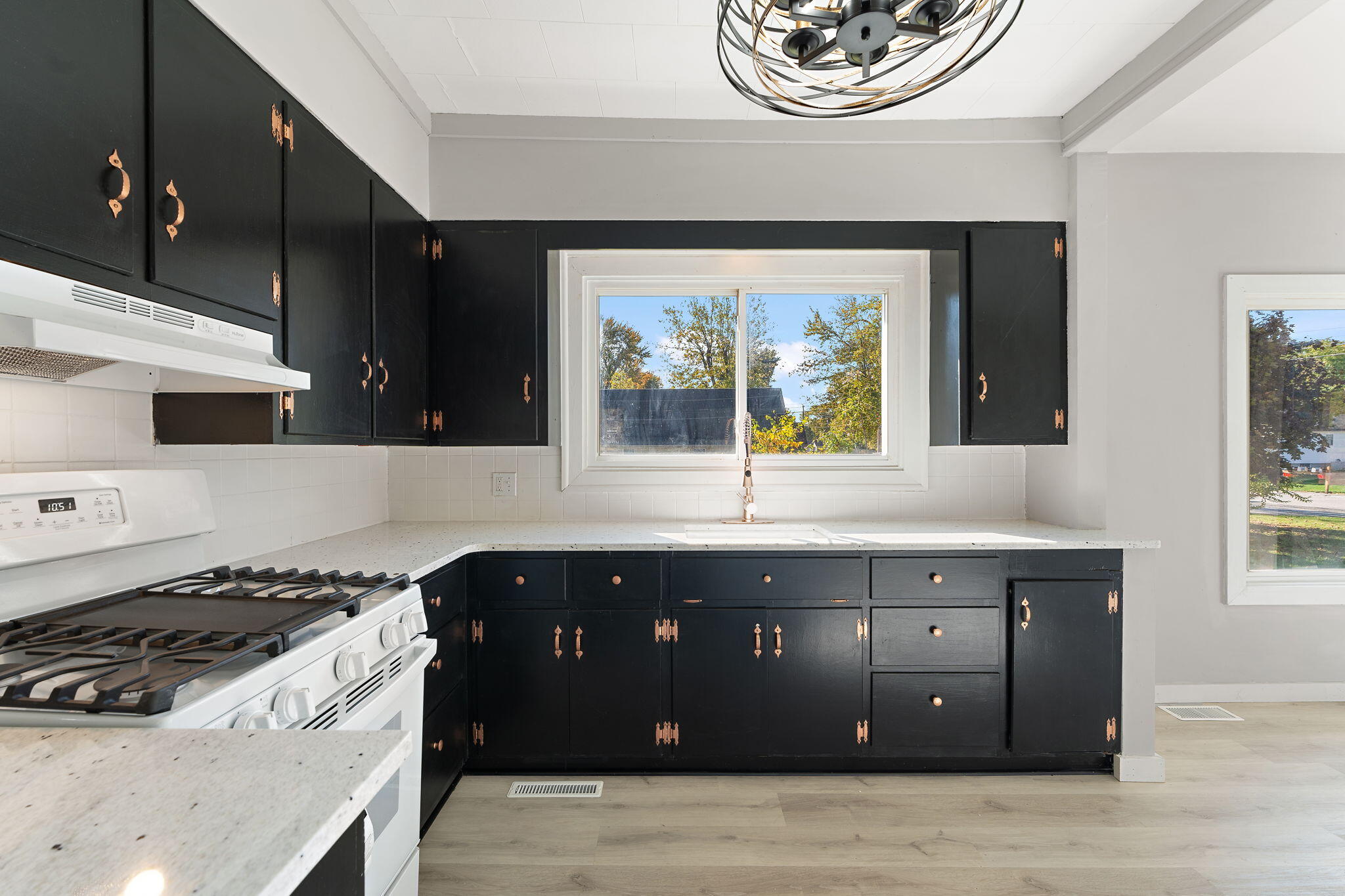 813 Carnation Street Southeast De Motte, IN 46310 - Photo 13 of 26 a kitchen with a stove and a window